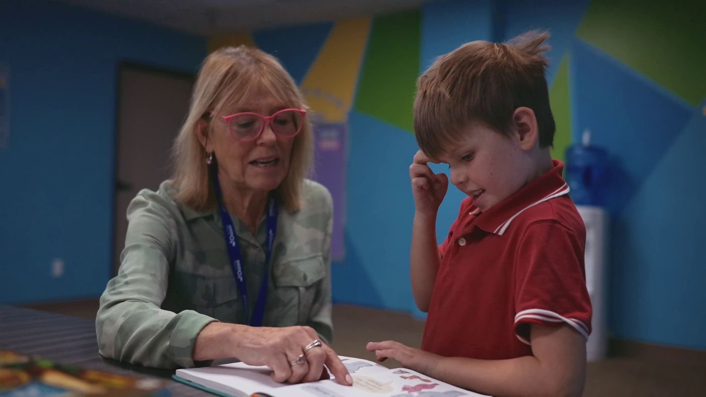 A Journey teacher reading one-on-one with a student