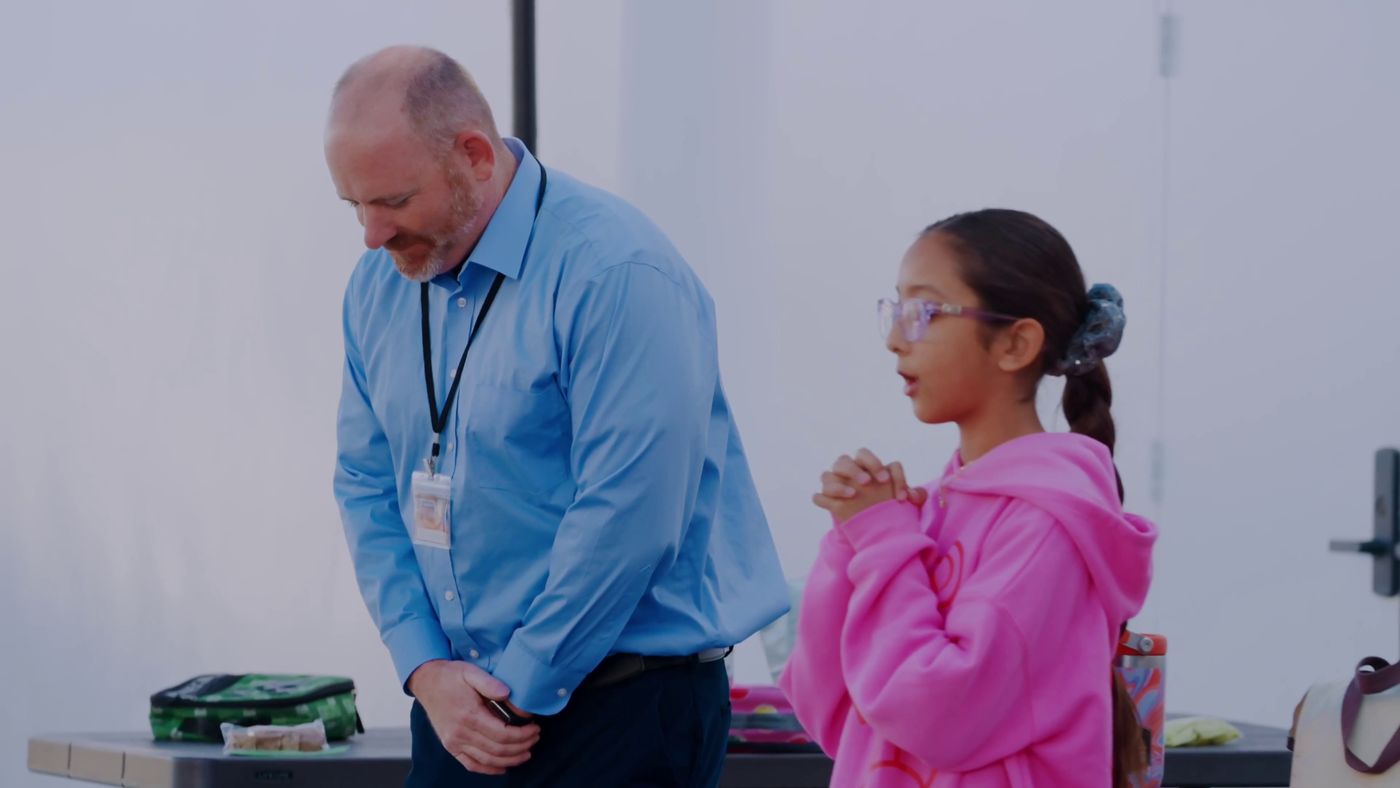 Principal Ryan Carpenter talking with a student